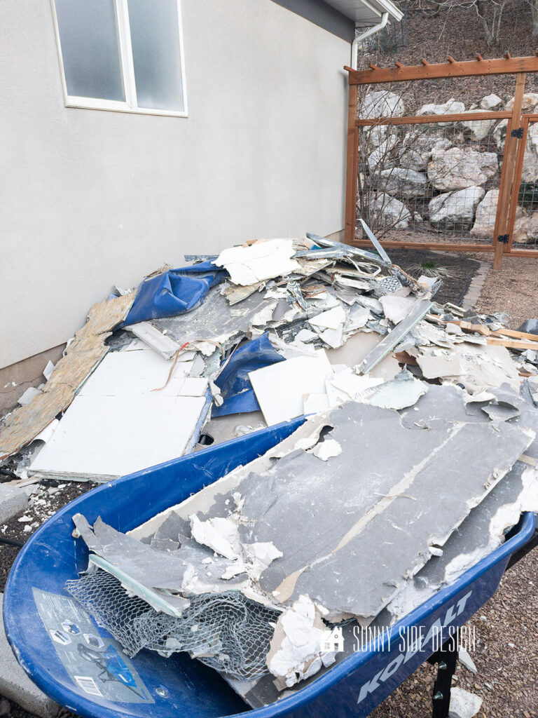 Pile bathroom rubble outside the bathroom window after the demolition.