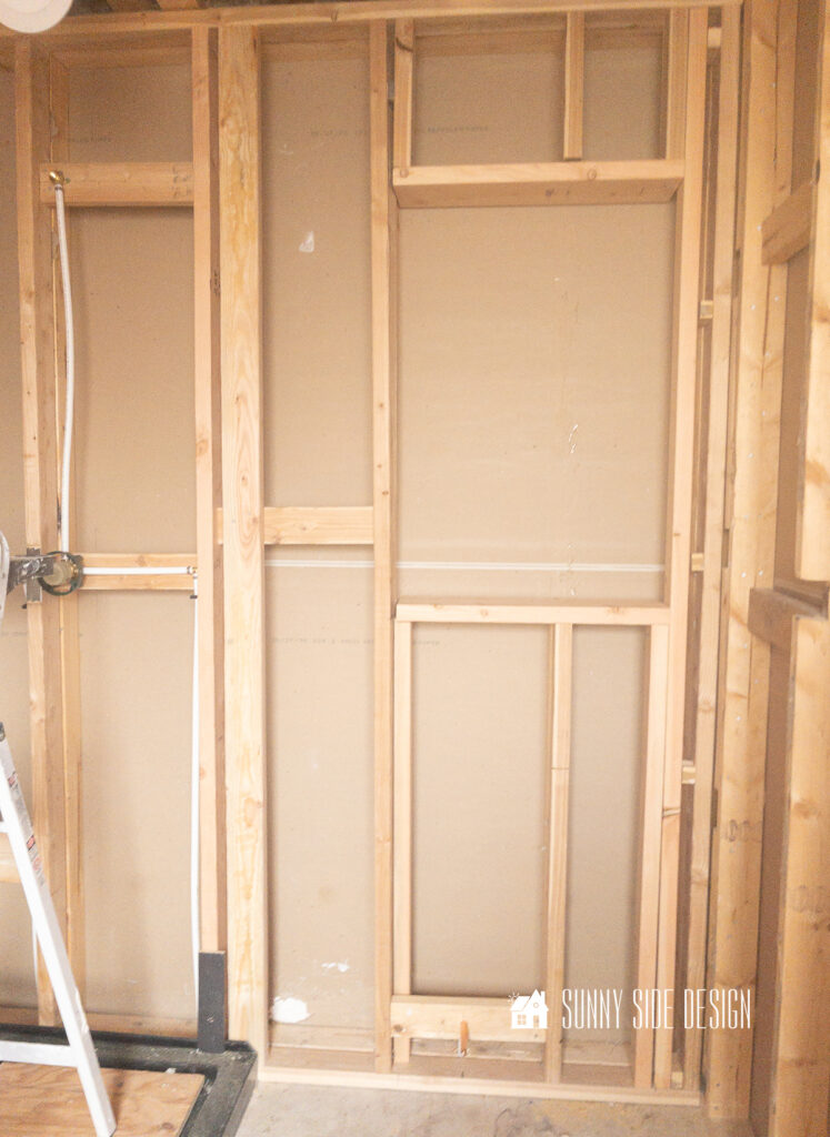 Wall studs are framed to accomodate built in wall shelves.