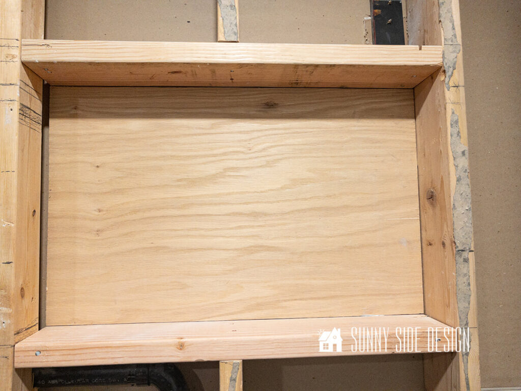 Framed out area with a plywood backing for the bathroom niche.