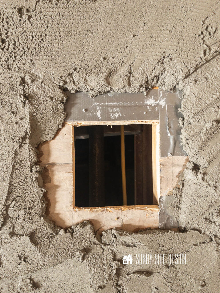 Mortar is spread on the bathroom subfloor, keeping an inch or two from the hole in the subfloor for the drain pipe.