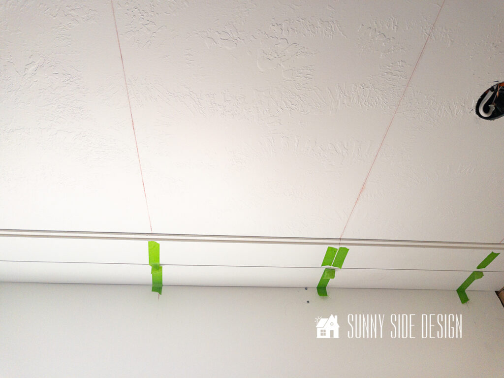 Two rows of install shiplap on ceiling.