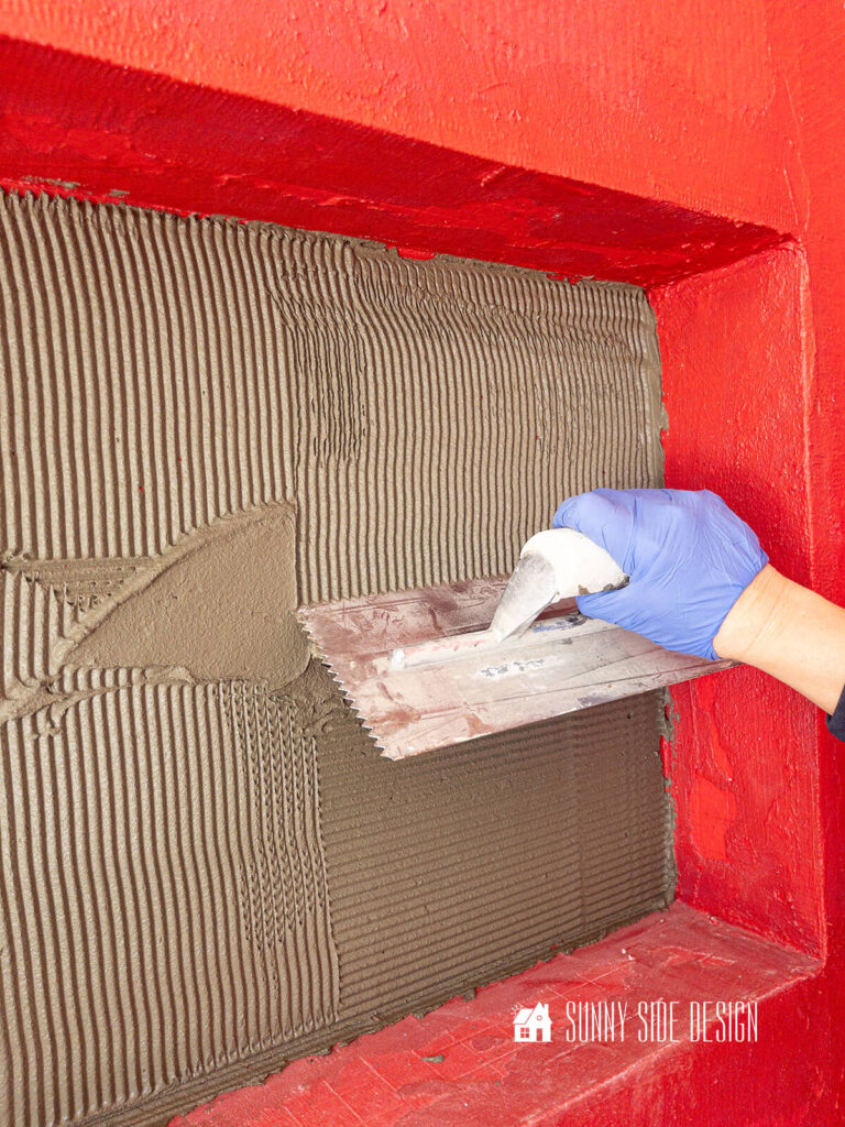 Trowel mortar into back of shower niche.