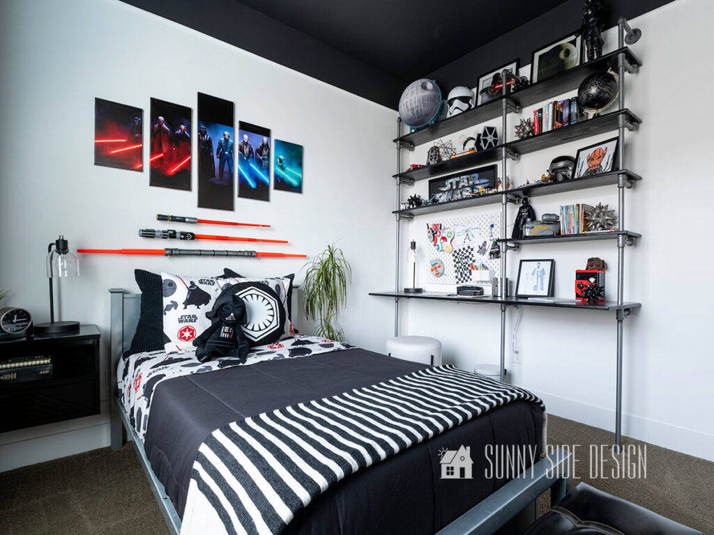 Home tour of Star Wars themed boys bedroom with a black ceiling, unique industrial light fixture, Star Wars art and lightsabers hung on the wall, Star Wars bedding and black curtains with white polka dot border. Wall mounted desk and shelves with Star Wars decor.
