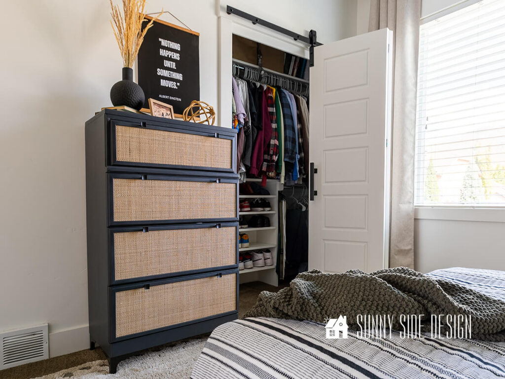 Bedroom tour with a bifold sliding barn door and closet organizer, Cane and black painted modern dresser with assorted black and natural finishes decor.