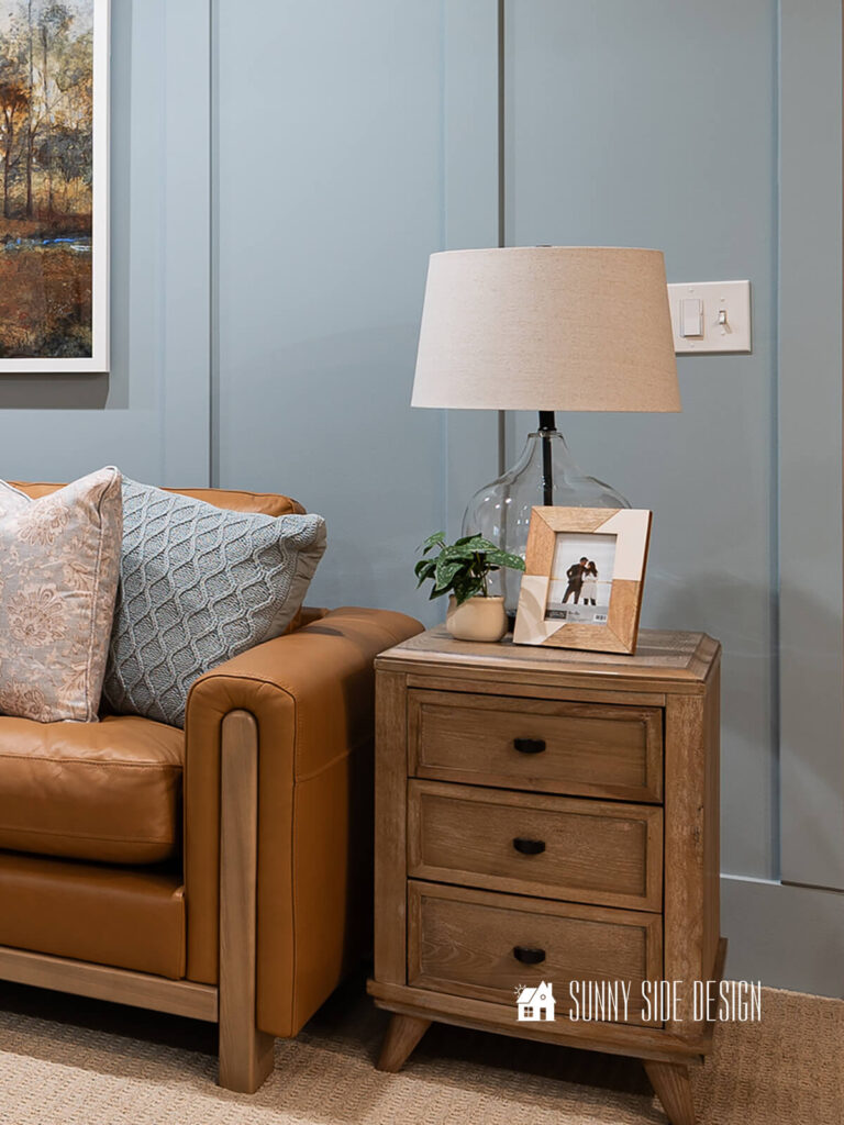 Brighten a dark room with reflective surface, such as a glass lamp on the side table with a white shade.