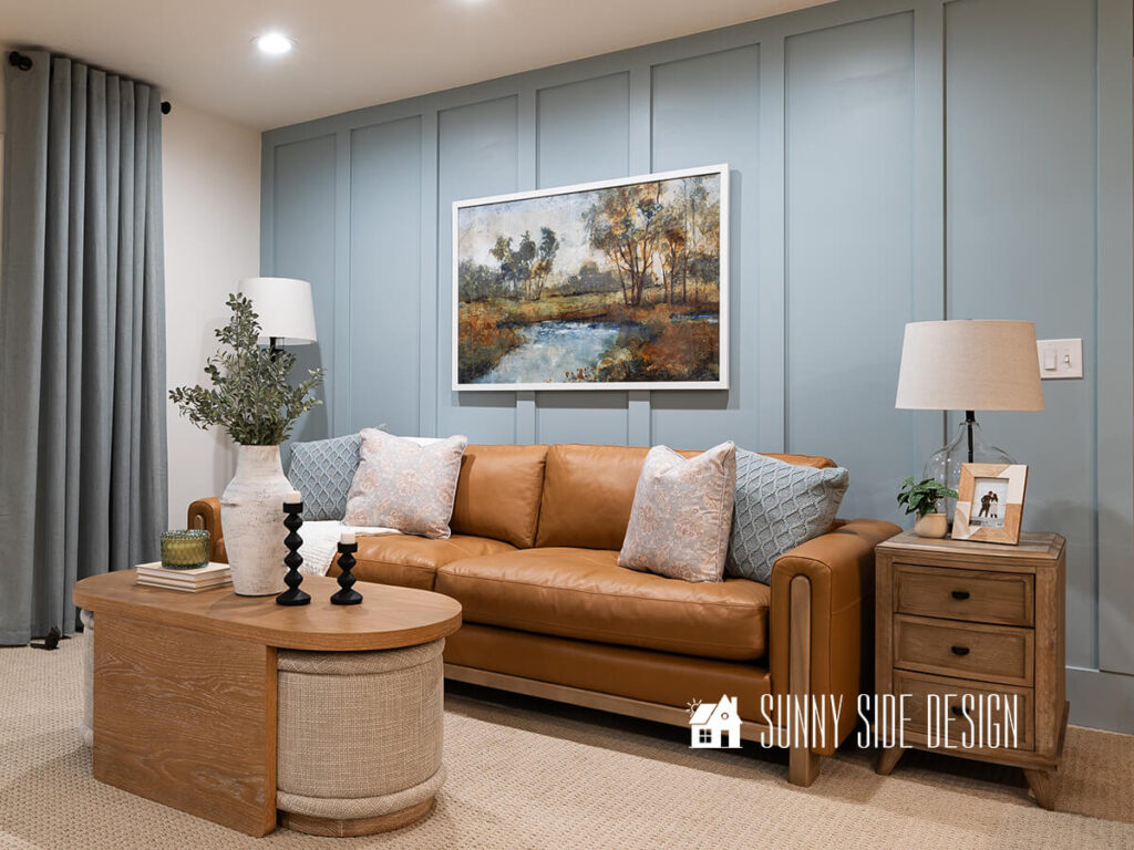 Lighten up a dark room with light wood tones. Cerused oak coffee table, natural wood side table with drawers and the slim lines of the caramel leather sofa with oak legs and trim brighten up the room.