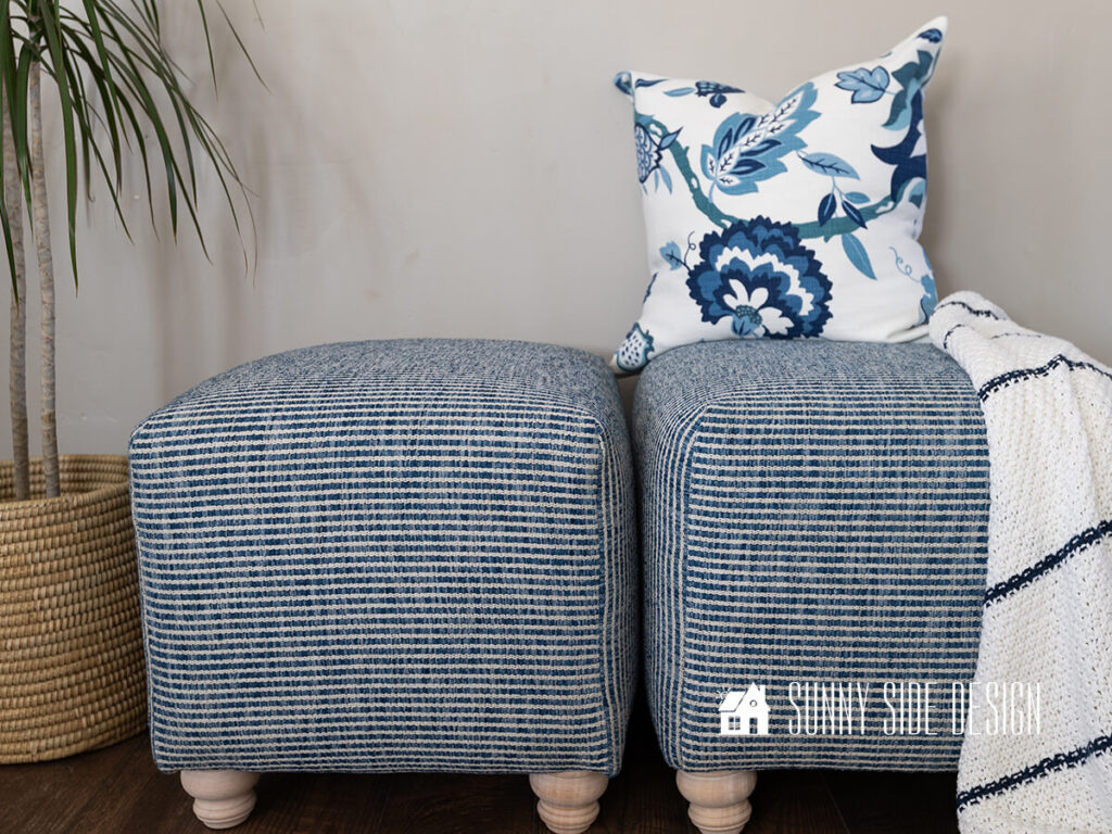 Thrift store ottomans get a makeover with fabric and new wood legs.