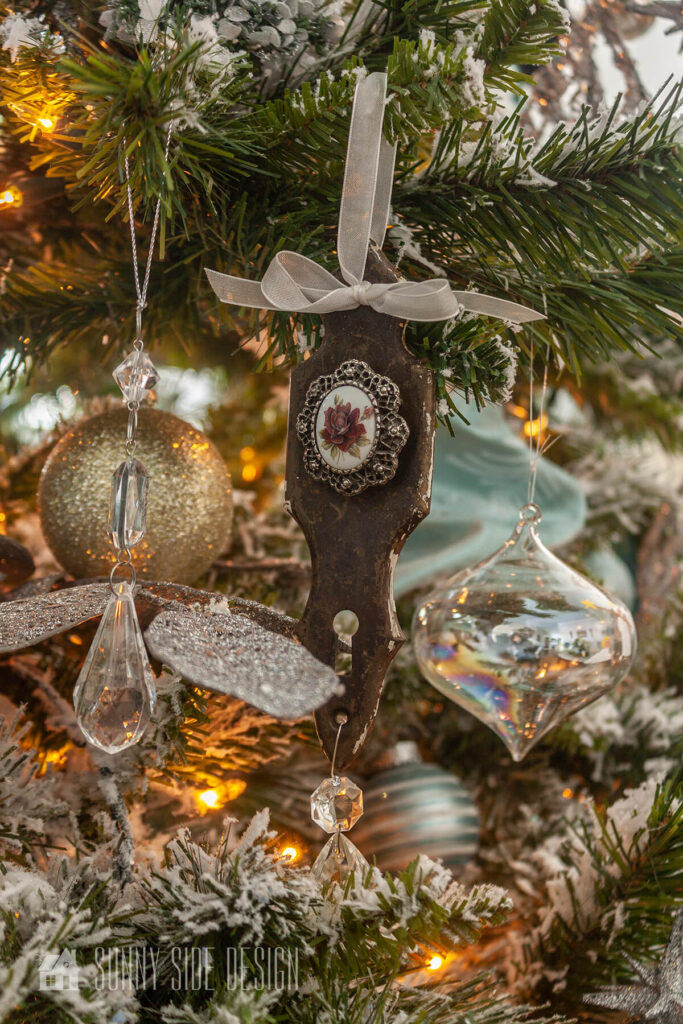 Vintage door handle plates and brooches are upcycled into pretty Christmas ornaments.