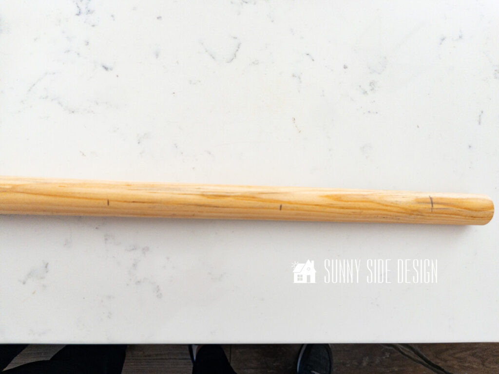 Pencil marks on a dowel showing placement for yarn colors.