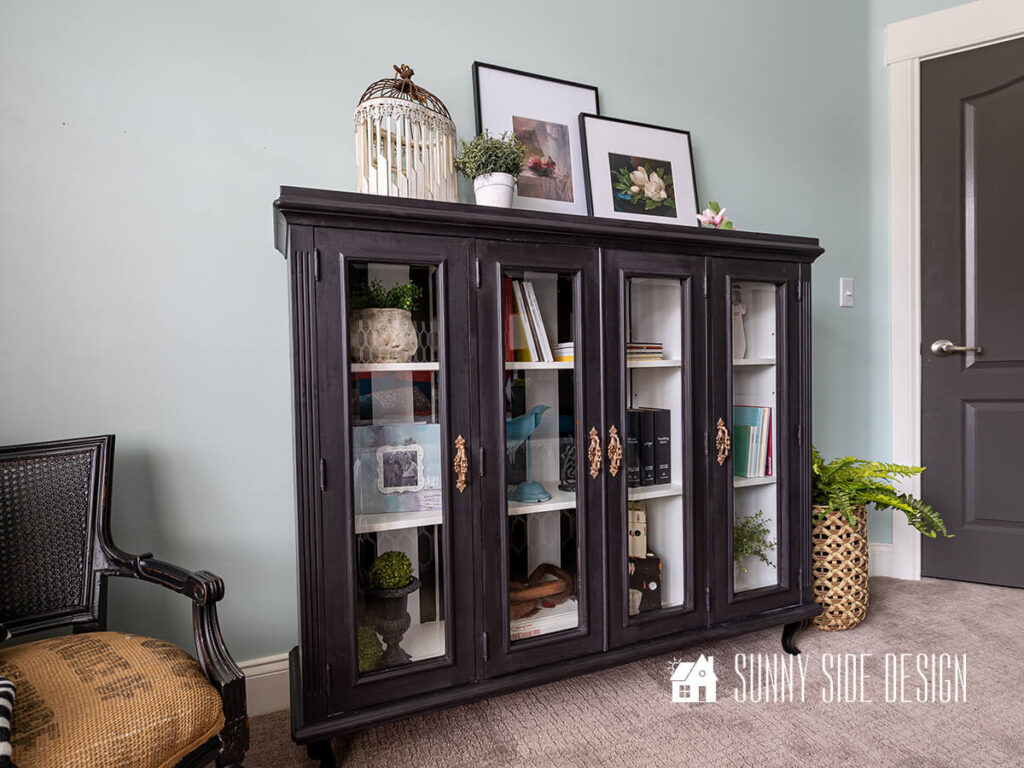 Upcycled Ideas: Thrifted hutch top is repurposed into a curio cabinet wih black and white paint and french inspired legs.