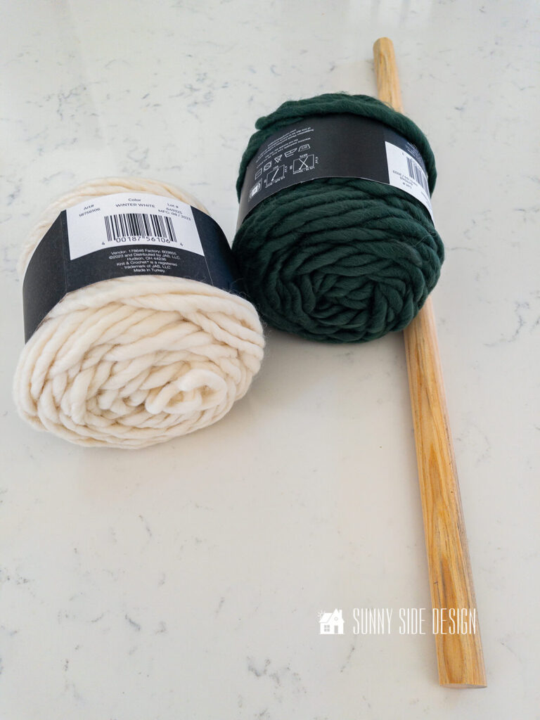 Three simple supplies of cream and green roving yarn and a dowel to make fiber wall art.