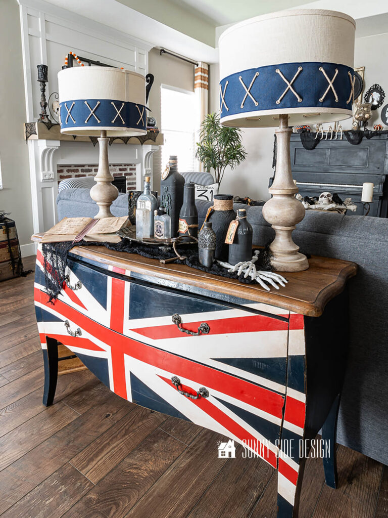 Bombay dresser is decorated with witch potion bottles and a book with the witches brew recipe.