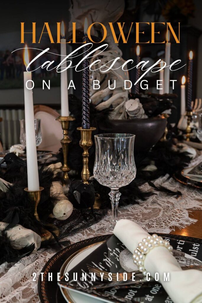 Pin image for Pinterest: Spooky Elegant Halloween Tablescape, black and white place settings , lace and creepy cloth table runner, black and white candles in vintage brass candlesticks, skeleton torso centerpiece in a black footed bowl.