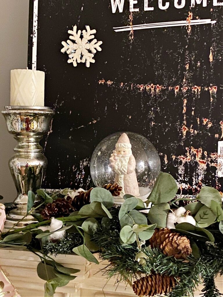 Christmas Decorating Ideas for Mantle with blush pink ribbon, ornaments and snowglobe.