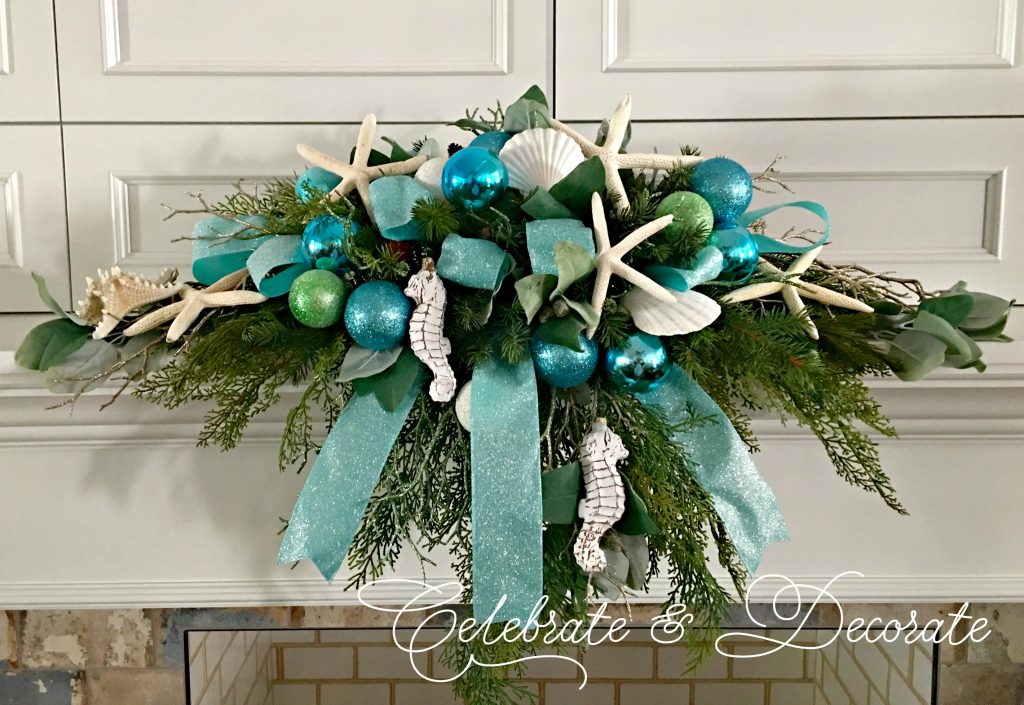 Coastal Christmas mantle piece with shells, starfish, seahorses and blue and green sparkle ornaments.