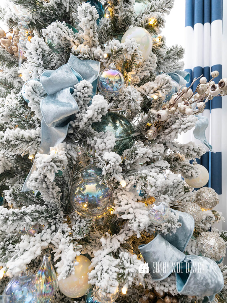 Triple looped blue velvet ribbon on a Christmas tree.