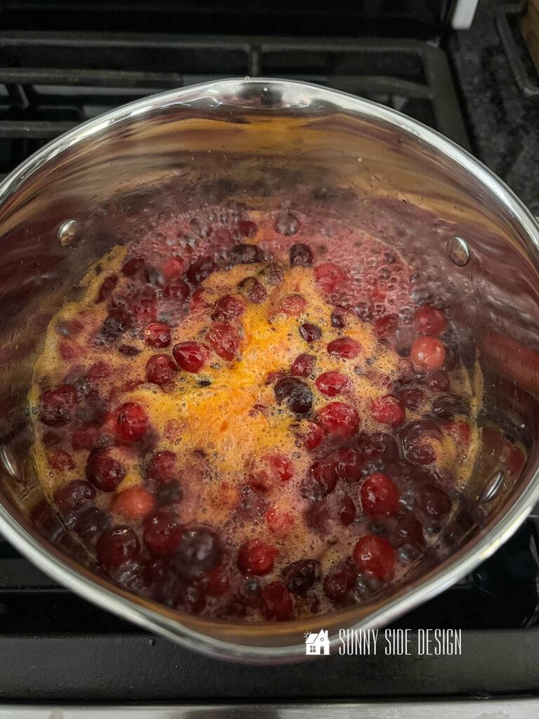 Cranberry sauce boiling on a gas range.