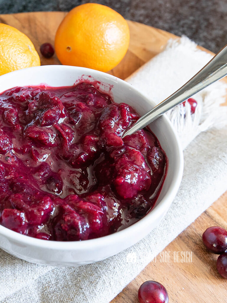 Easy cranberry sauce recipe with orange and ginger in a white bowl.