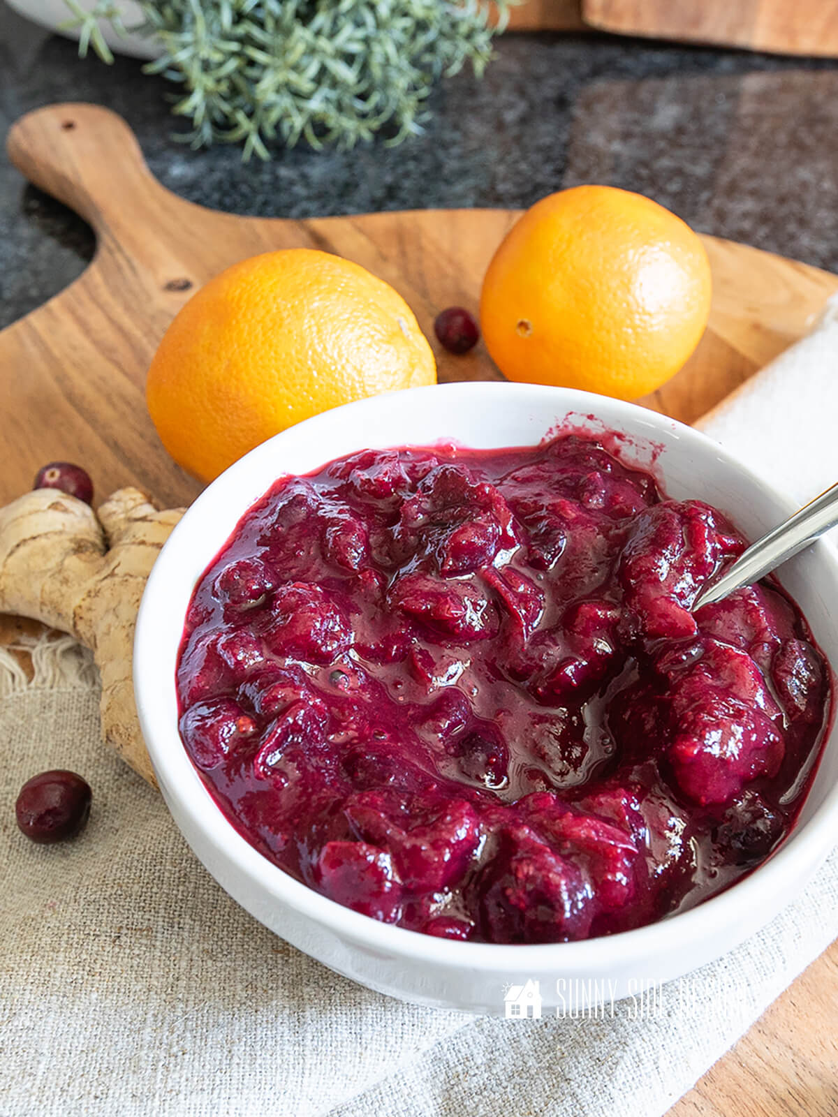 Easy cranberry sauce recipe with orange and ginger in a white bowl.