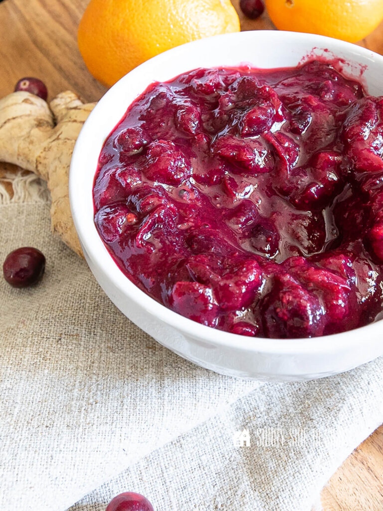 Easy cranberry sauce recipe with orange and ginger in a white bowl.