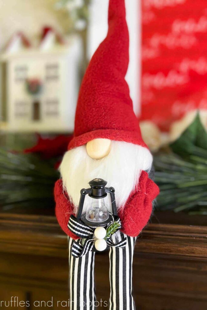 Christmas Gnome shelf sitter is placed on the edge of the mantle for Christmas.