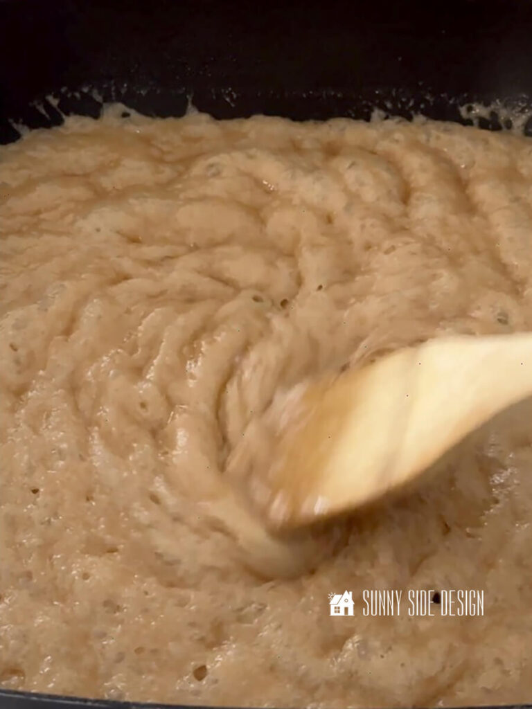 Stirring toffee with a wooden spoon.