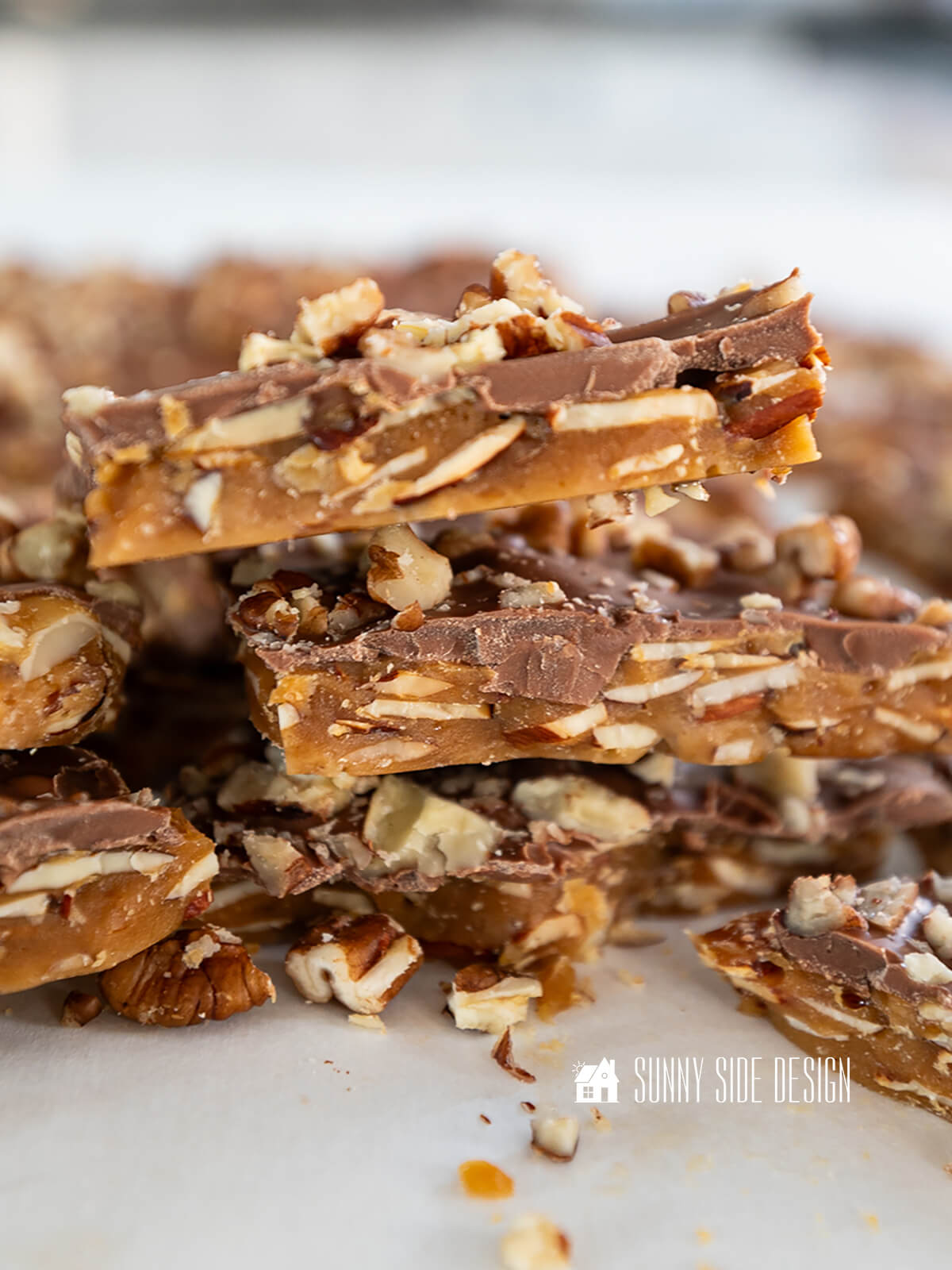 Stacked homemade english toffee with nuts.