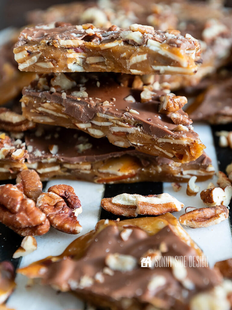 Stacked homemade english toffee with nuts.