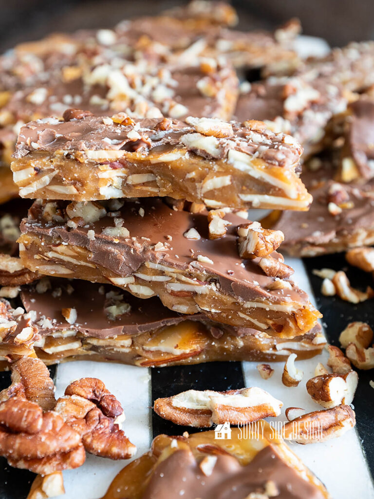 Stacked homemade english toffee with nuts.