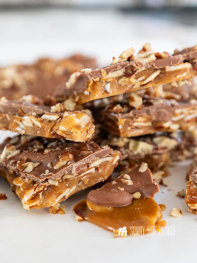 Stacked homemade english toffee with nuts.