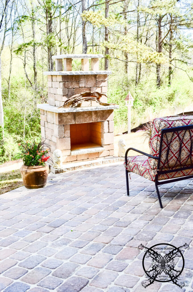 Vintage looking pavers in a linear placement with an outdoor fireplace and seating area.