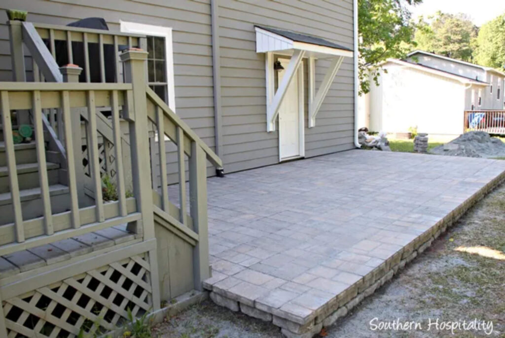 Raised paver patio placed against the house.