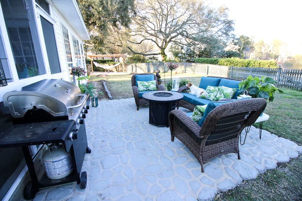 Faux pavers with a quickcrete cement patio. Styled with outdoor furniture and grill.