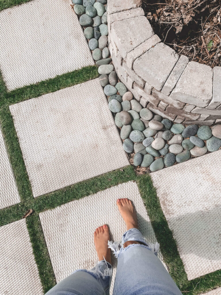 Concrete and artificial turf patio with a DIY fire pit.