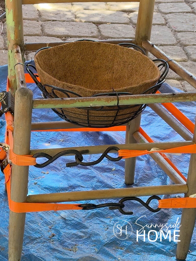 a coir liner is placed in the repaired chair planter.