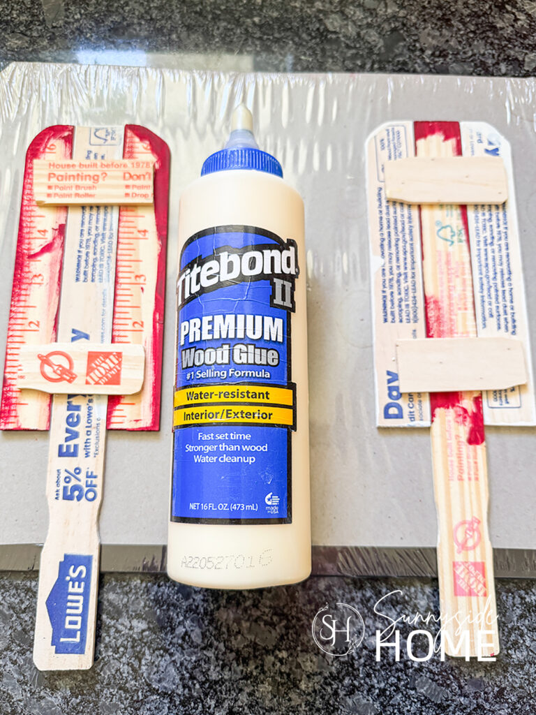 Wood glue is used to secure the patriotic popsicle decorations together.