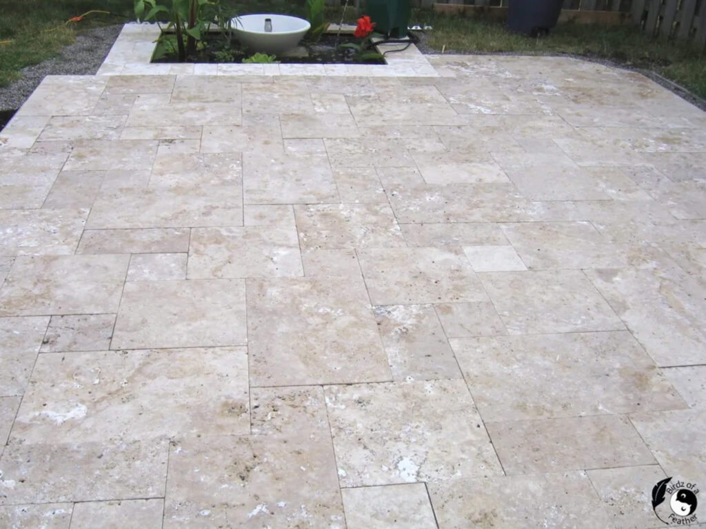 Travertine stone DIY paver patio with a modern pond.