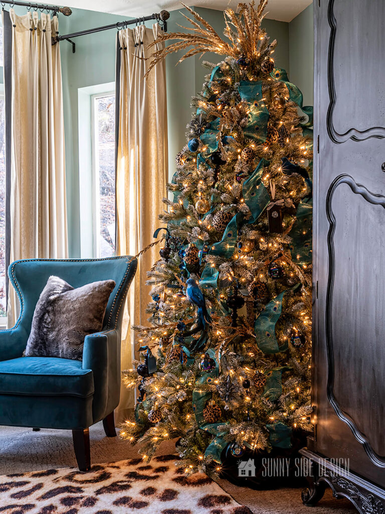 Bedroom decorated for Christmas with a gold and blue tree.