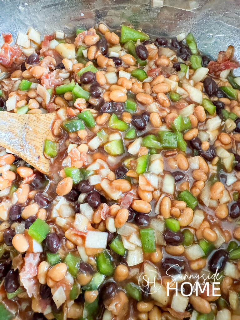Ingredients for bean recipe combined in a large mixing bowl.