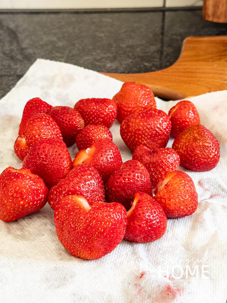 Remove excess water from strawberries with a towel.