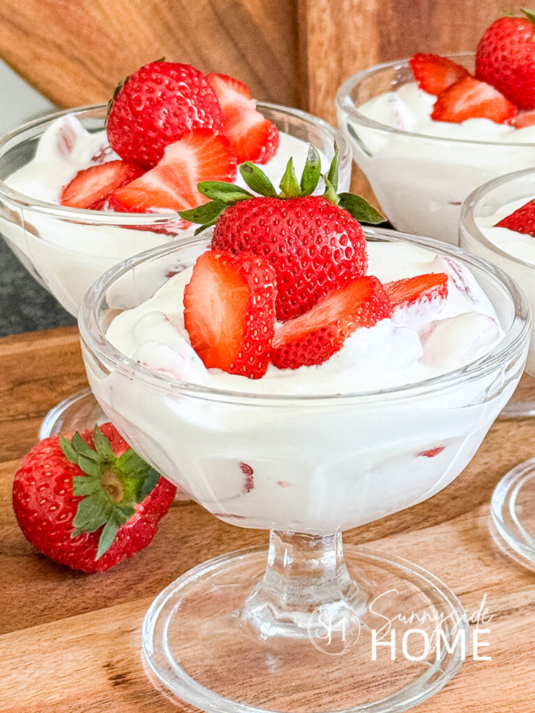 Mexican strawberries and creme in a glass dessert dish garnished with fresh strawberries.