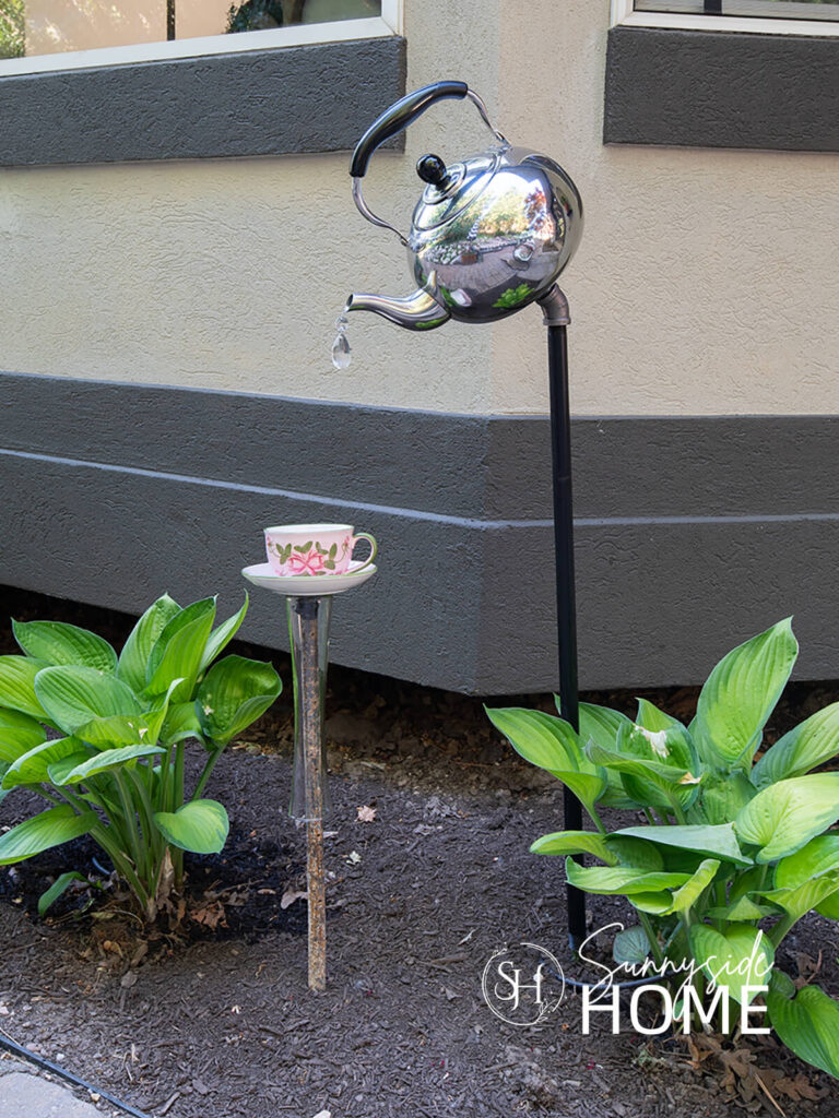 Garden teapot decor placed in the flower garden.