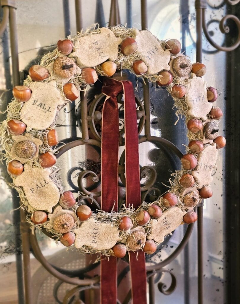 DIY acorn wreath with salt dough and burgundy velvet ribbon.