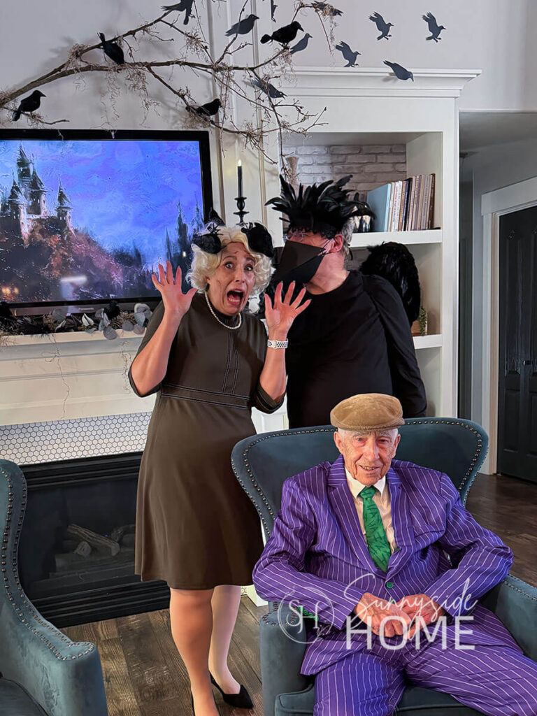 Decorating for Halloween with a Spooky Bird theme. Woman birds in hair and a man dressed in a bird costume for a Halloween party with a spooky bird theme.