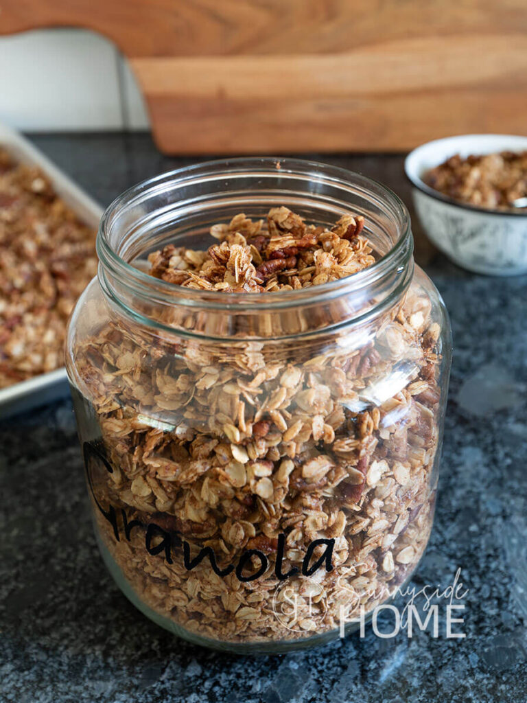 Homemade granola in a labeled glass jar.