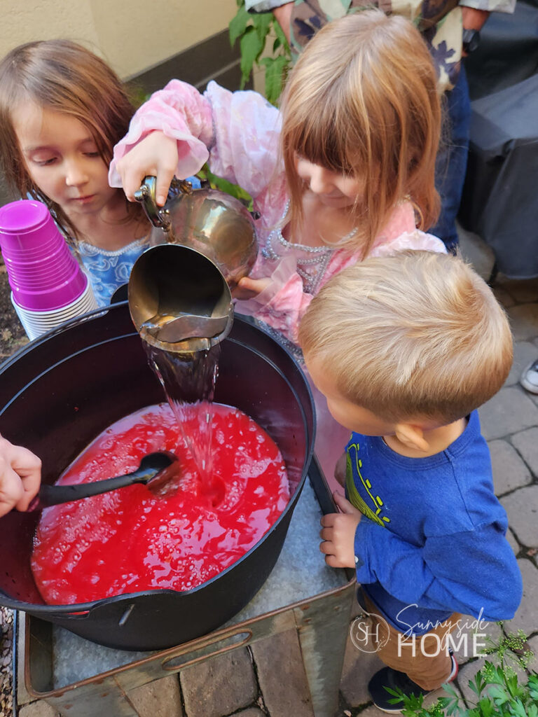 Kids helping make Witches brew at Halloween Party.