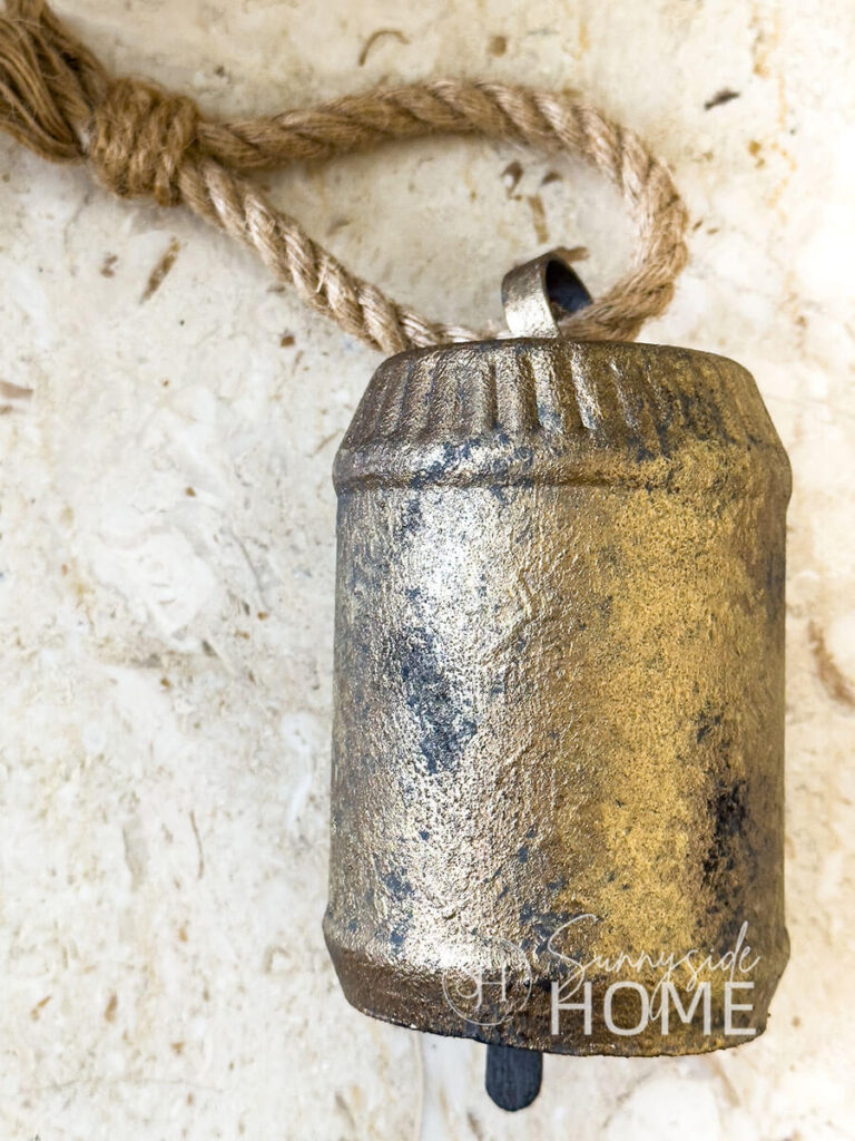 DIY faux brass Christmas bell made from recycled materials.