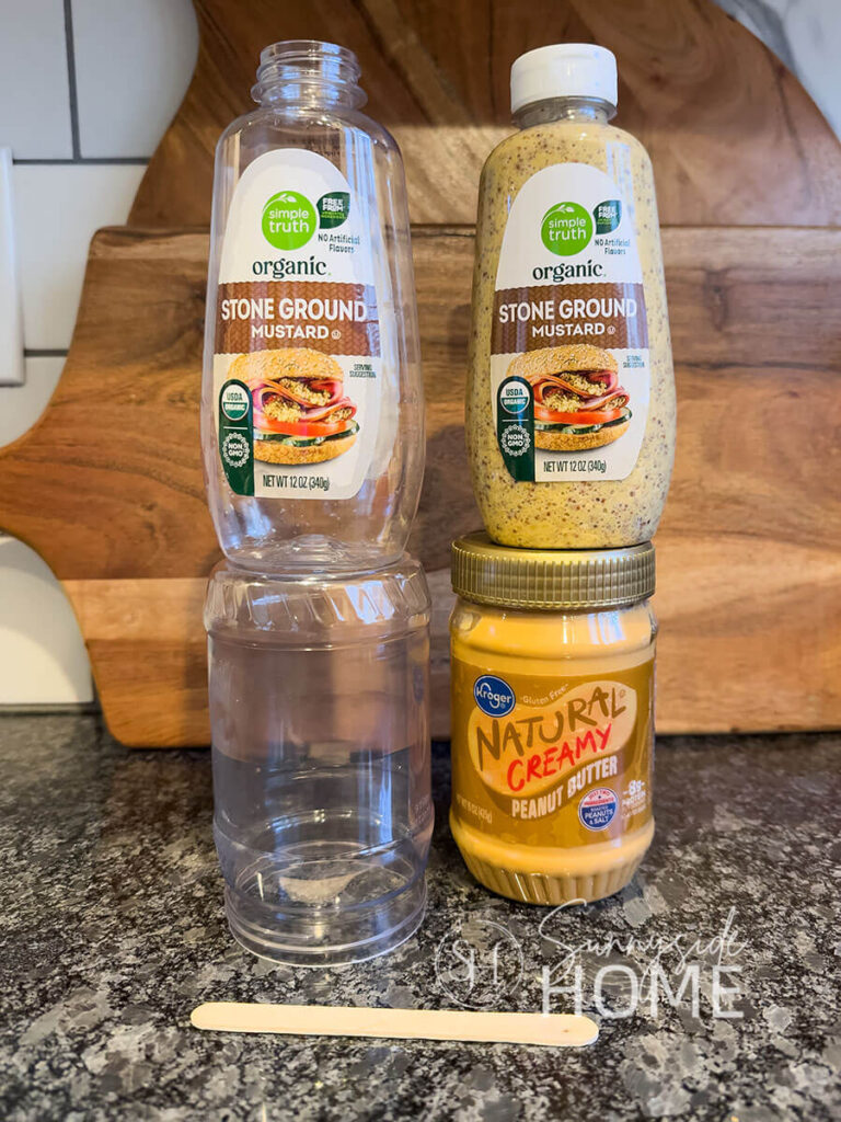 Recycled mustard and peanut butter containers that will be used for Christmas bells.