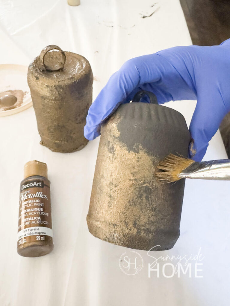 Metallic Rich Espresso craft paint is dabbed onto the DIY Christmas bell.
