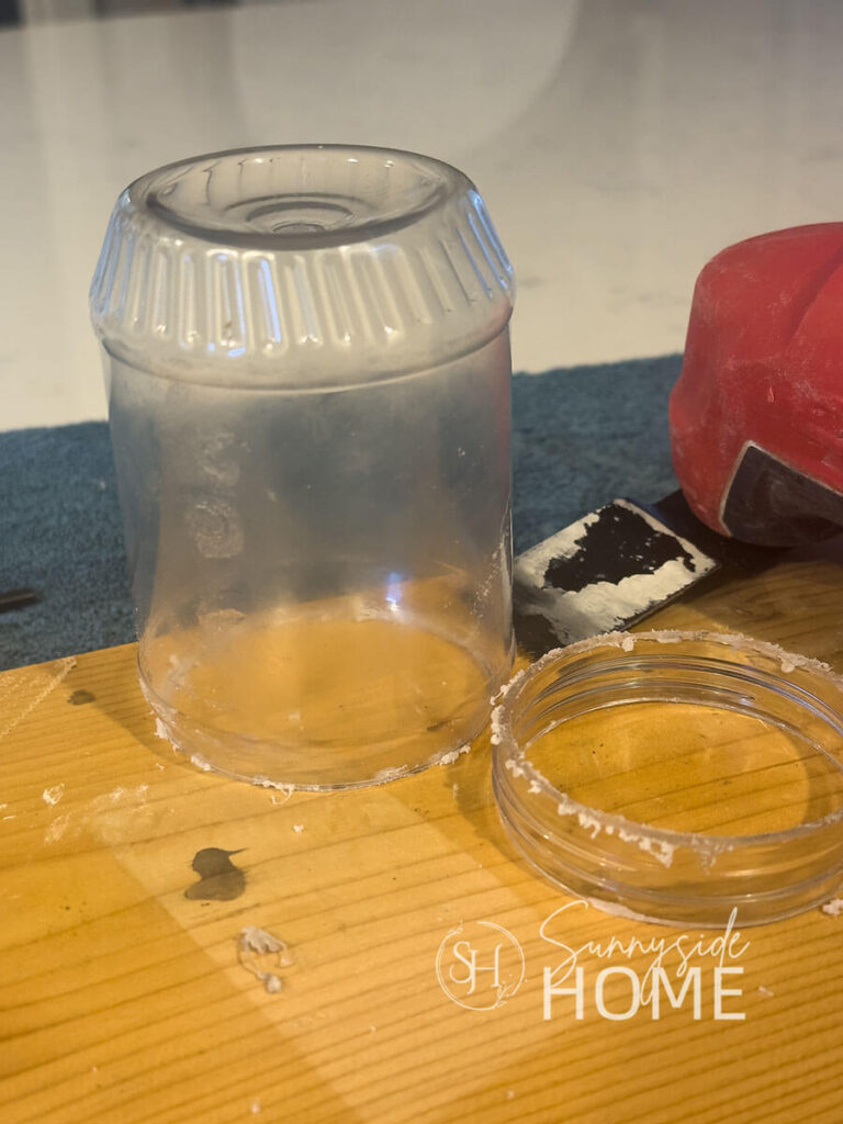 Rim of peanut butter jar is removed with an oscillating tool.